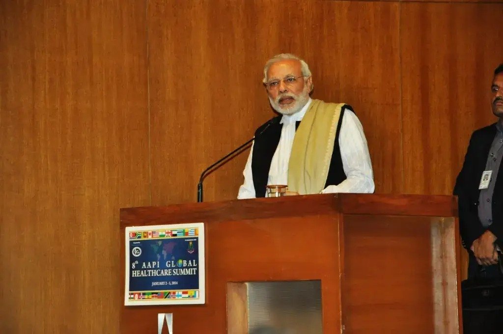ITT event entrance with red and green carpet and pink lighting on white structure with ITT branding