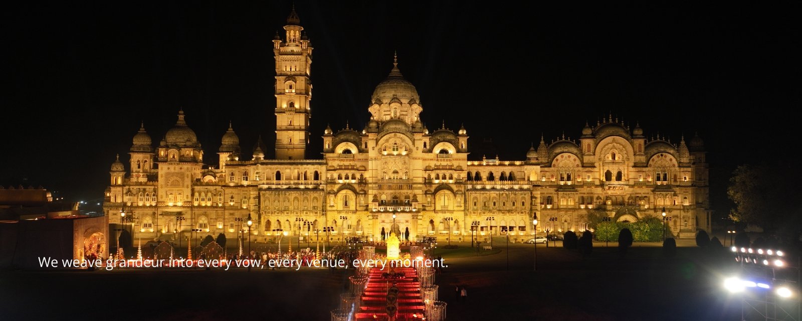 Elegant wedding setup with floral decorations and seating, white chairs and pastel flowers on tables, soft natural lighting, sunset background
