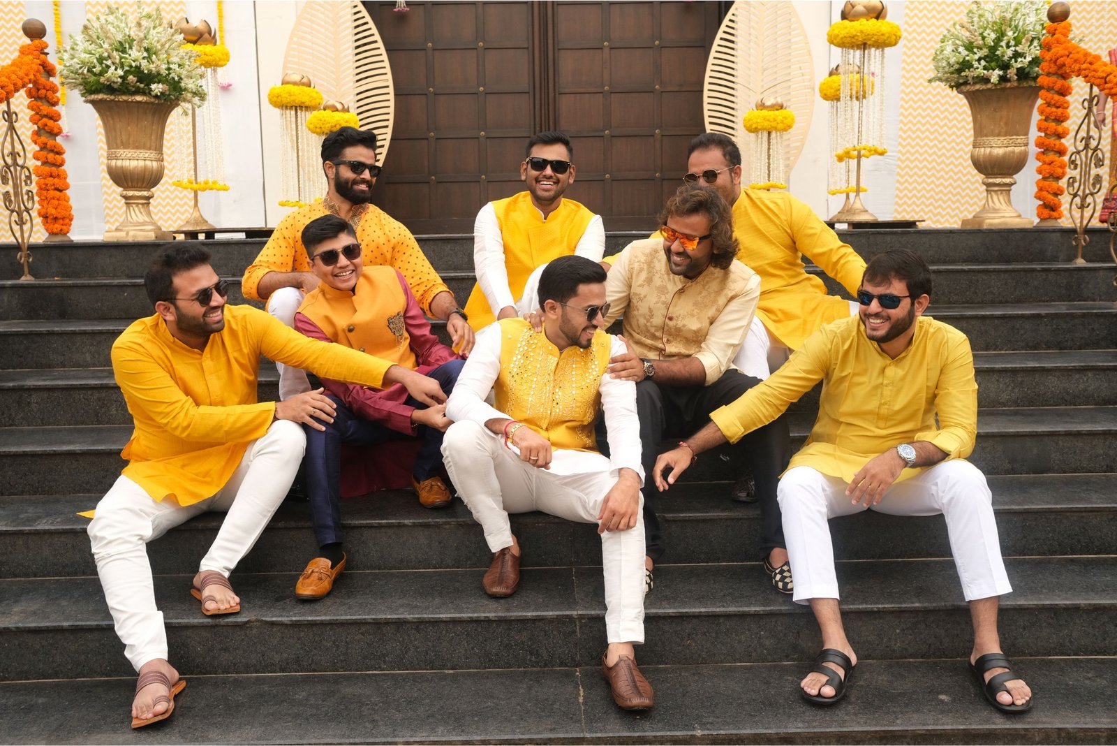 Group of men posing with large cartoon character inflatable figures at night outdoors