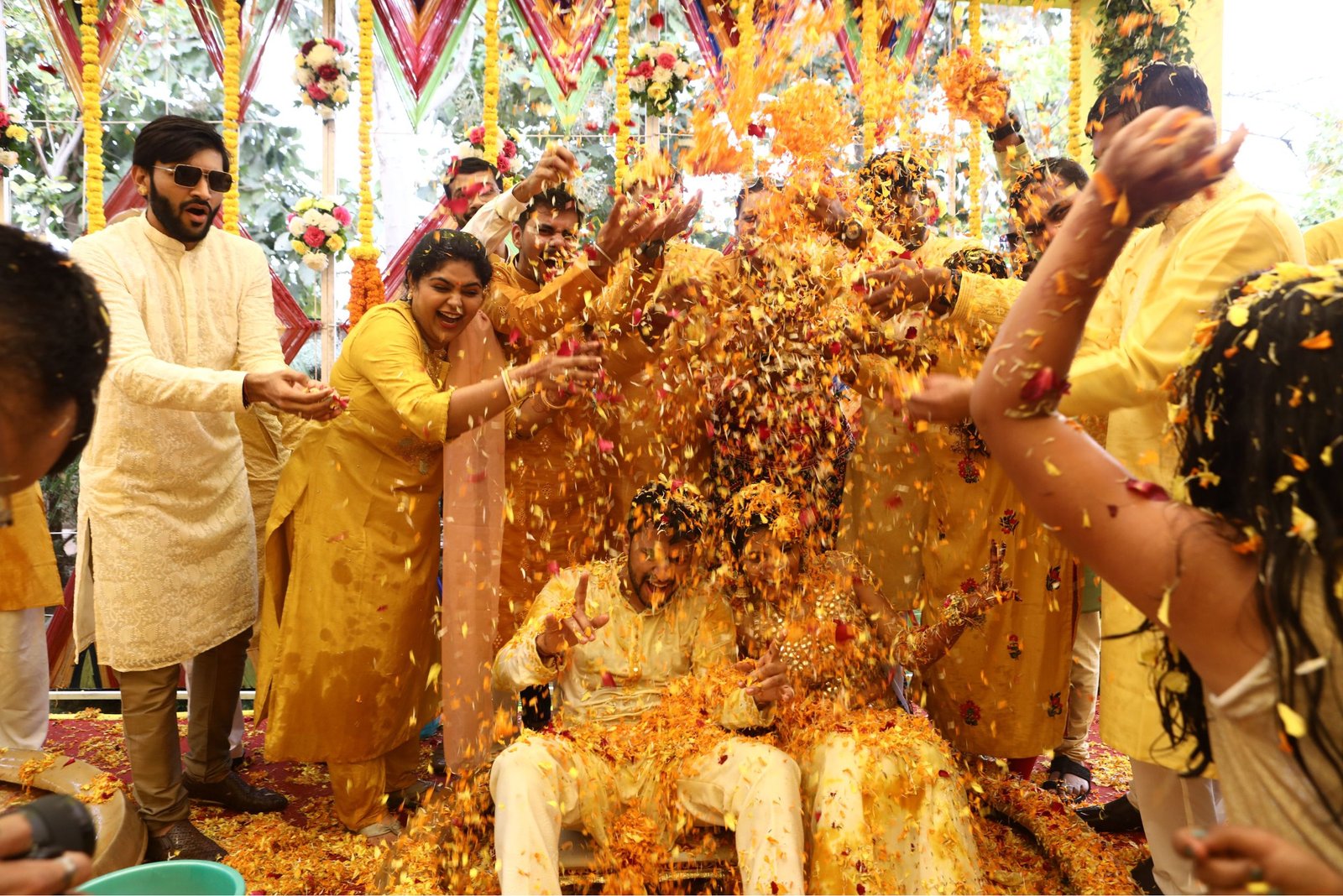 Men lighting ceremonial lamp at event with ITT banner in background
