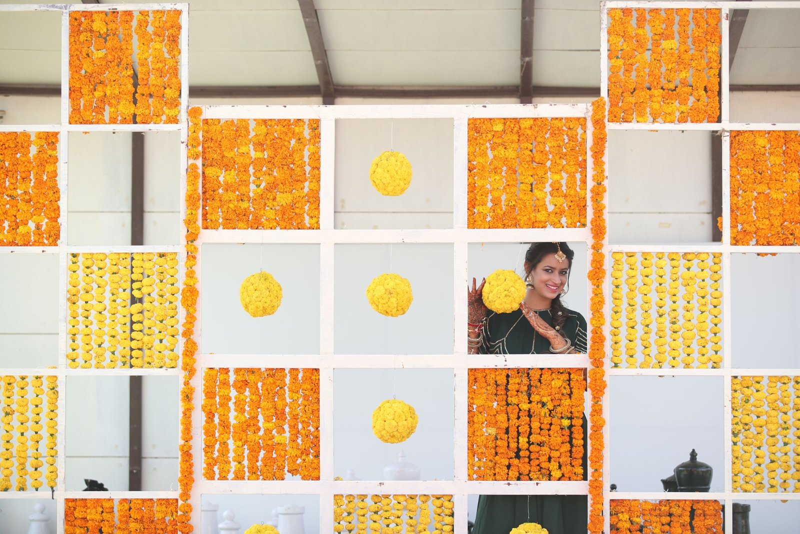 Balloon arch in orange, black, and white colors framing an ITT logo board lit with warm lights