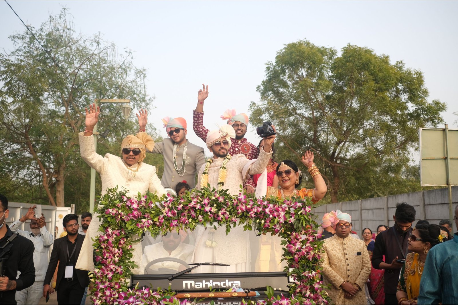 Balloon arch in orange, black, and white colors framing an ITT logo board lit with warm lights