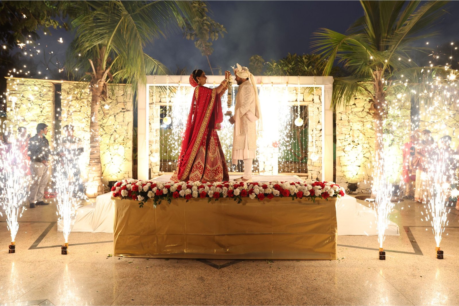 Men lighting ceremonial lamp at event with ITT banner in background