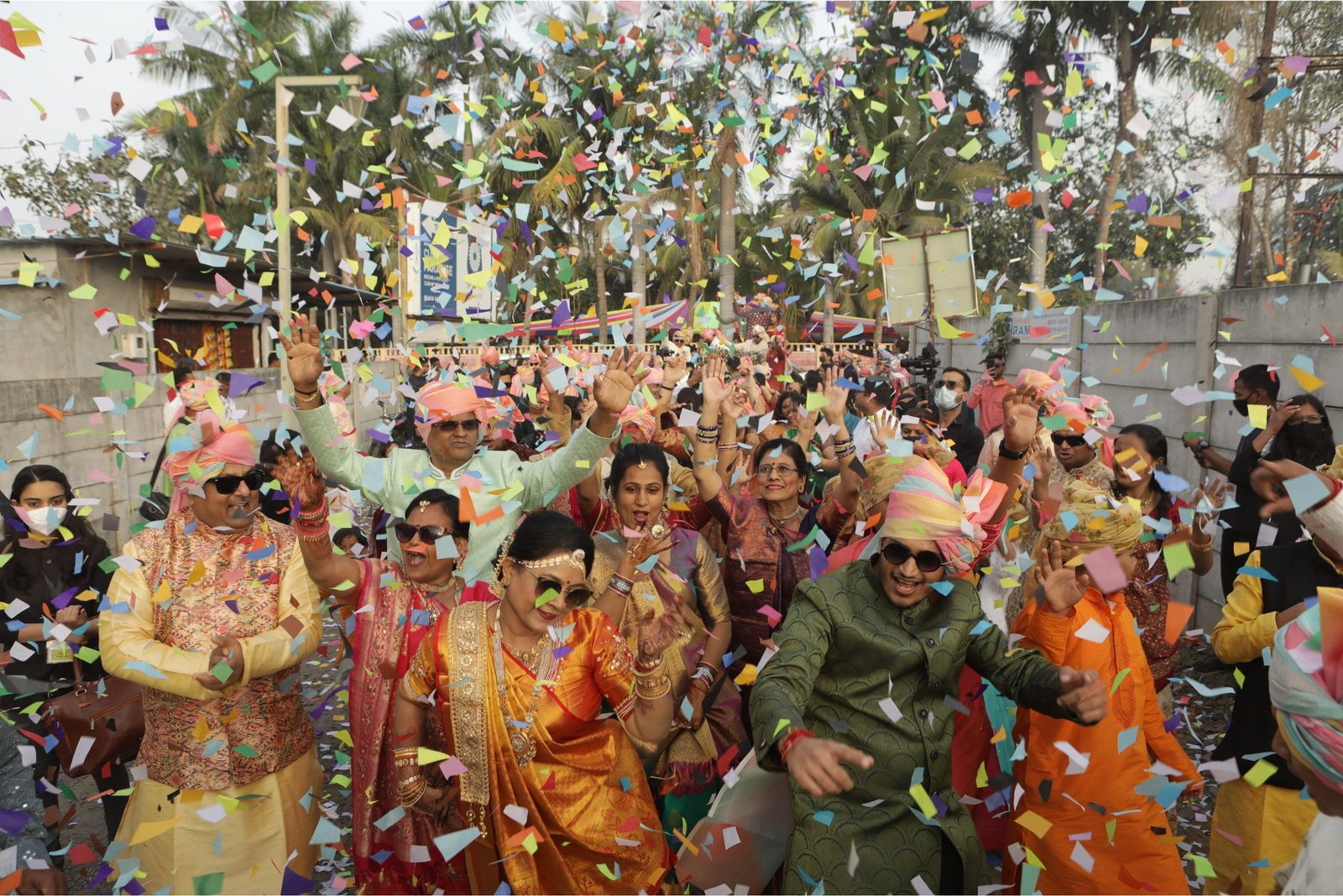 Men lighting ceremonial lamp at event with ITT banner in background