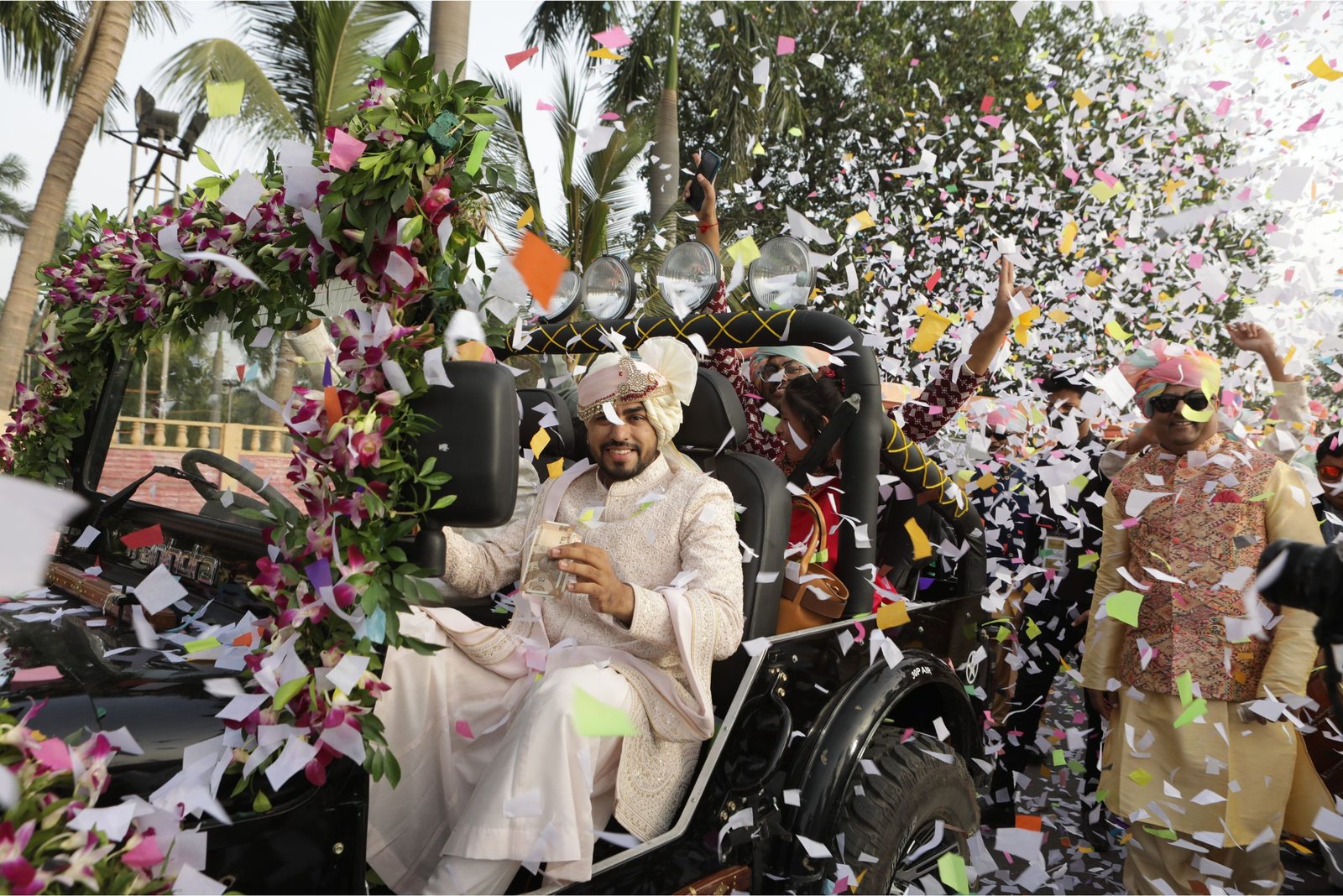 Men lighting ceremonial lamp at event with ITT banner in background