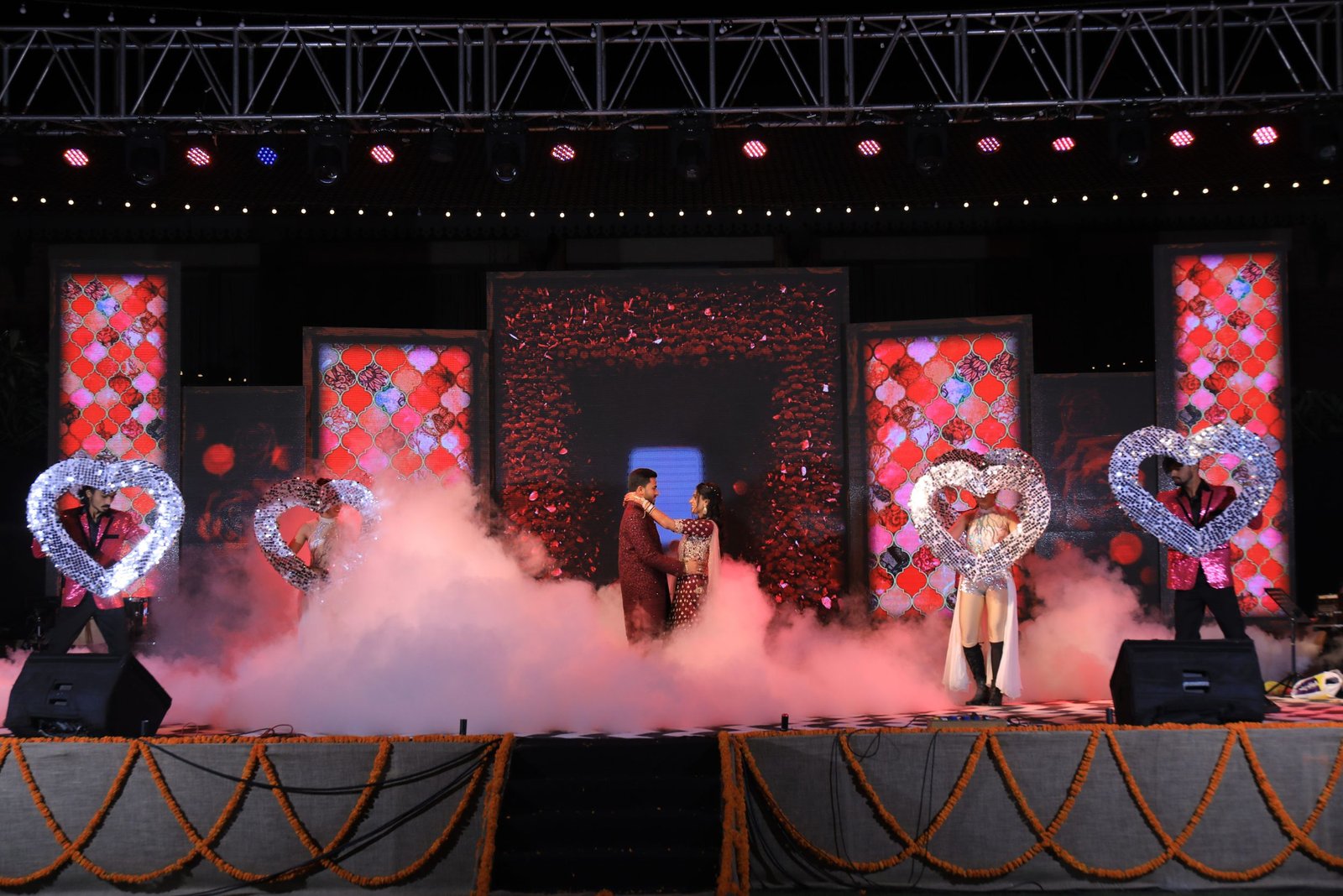 ITT event entrance with red and green carpet and pink lighting on white structure with ITT branding
