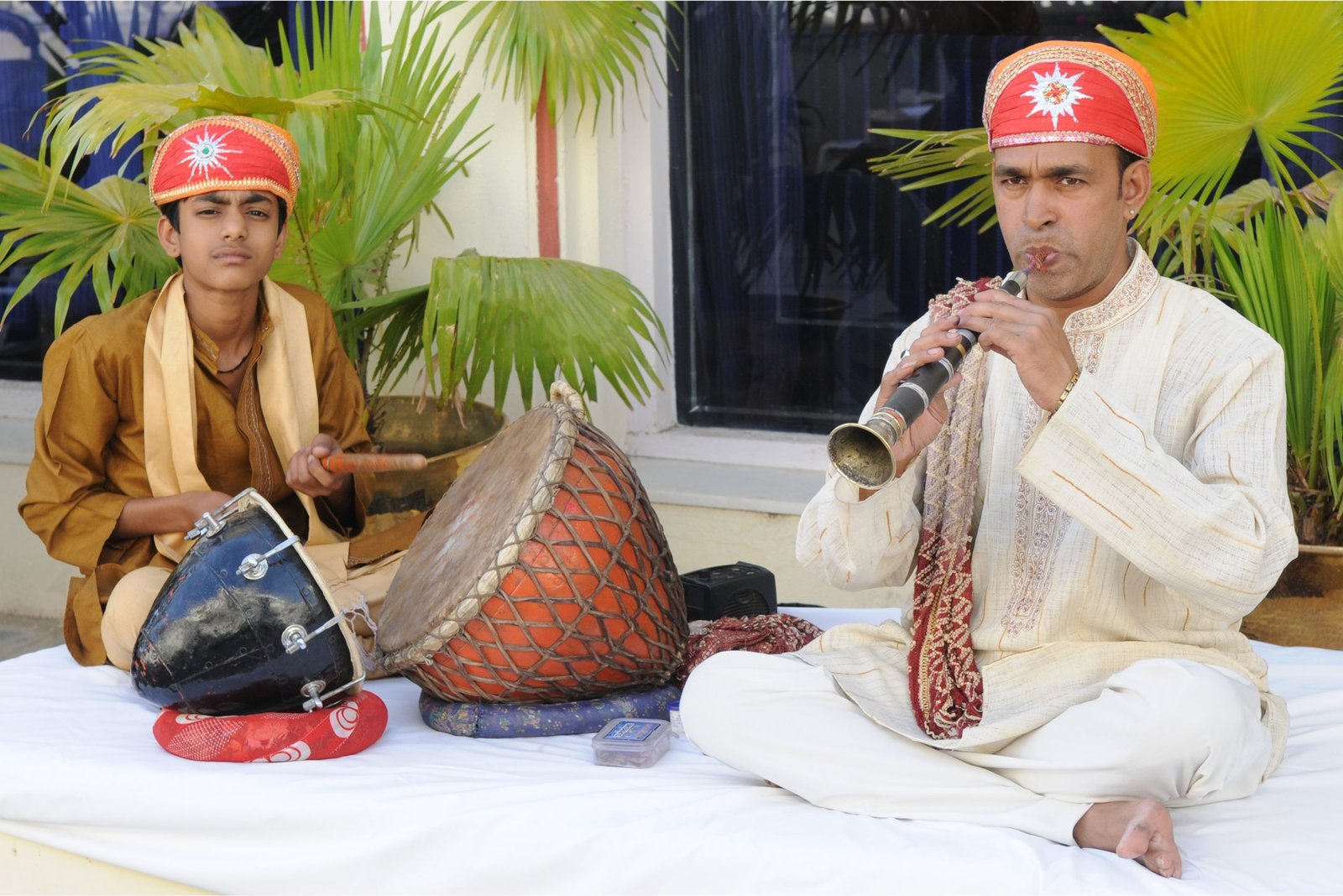 ITT event entrance with red and green carpet and pink lighting on white structure with ITT branding